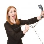Young business owner taggled up in phone wires